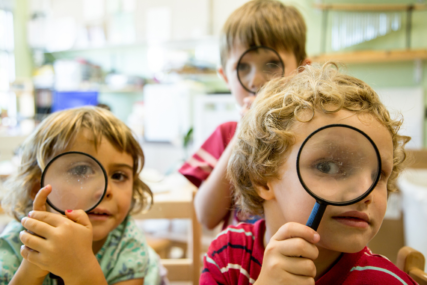 Children looking through magnifying glass