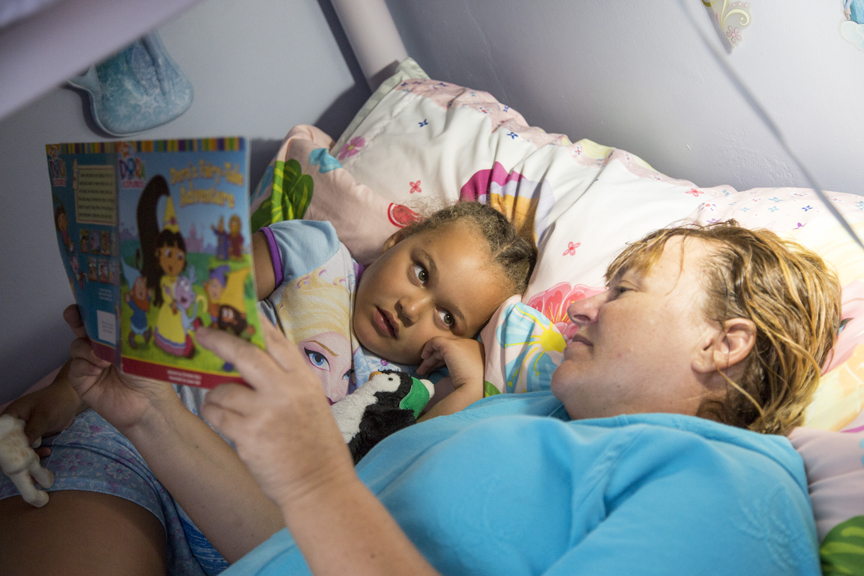 Mother reading to daughter