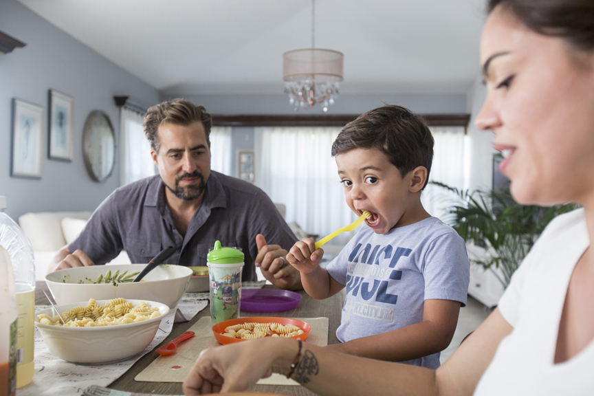 Boy eating at family dinner