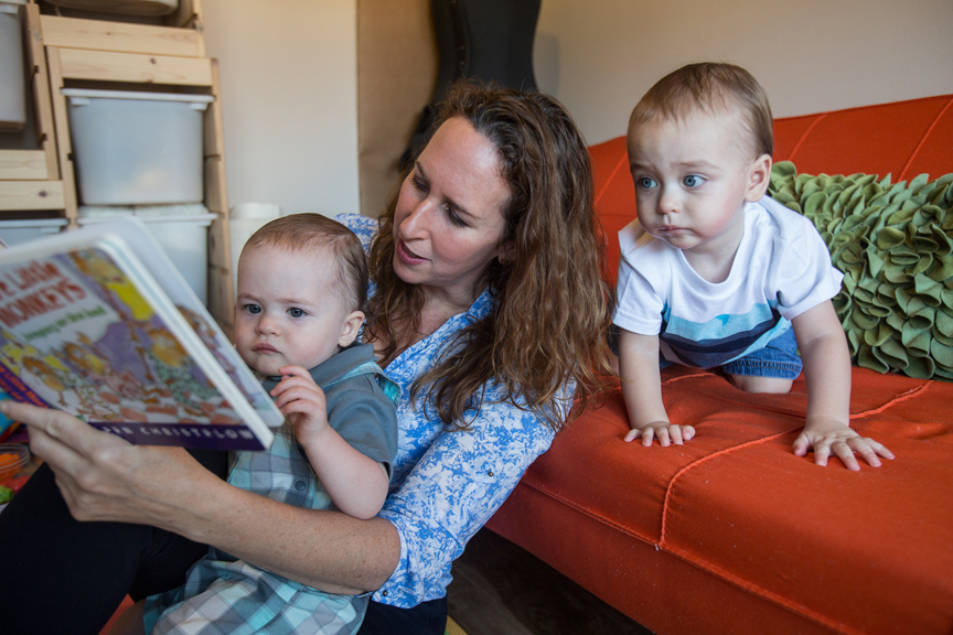 Mother reading to two young boys