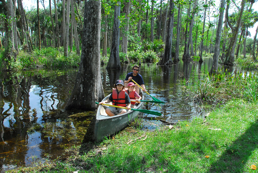 Man and young children in canoe