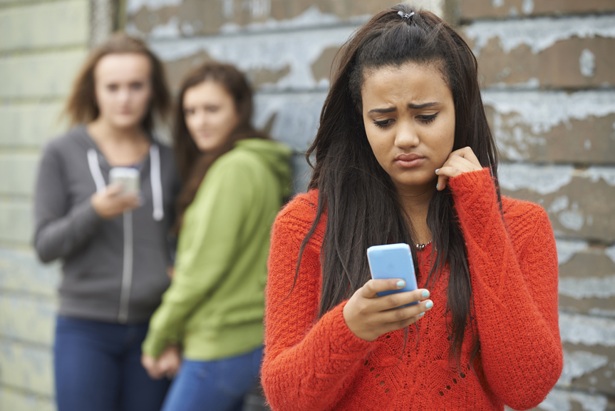 Concerned teenage girl looking at phone