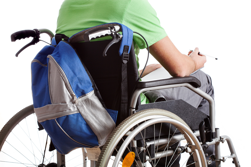 Person in a wheelchair with a backpack attached to it