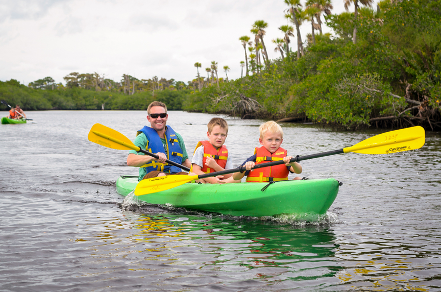 Man and two young boys in kayak