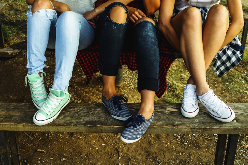 Teenagers sitting on picnic table