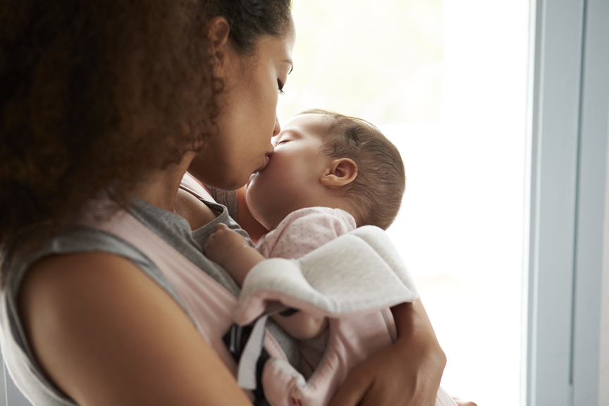 Mother kissing infant