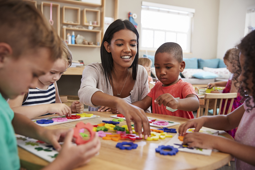 Child care teacher working with young children