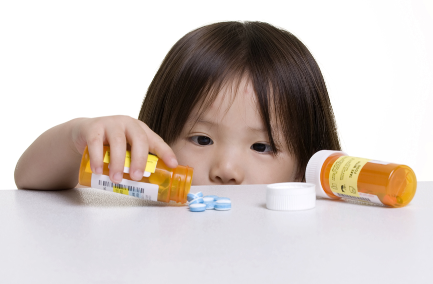 Young girl spilling medicine