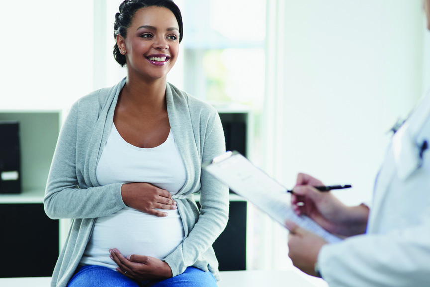 Pregnant woman talking to doctor