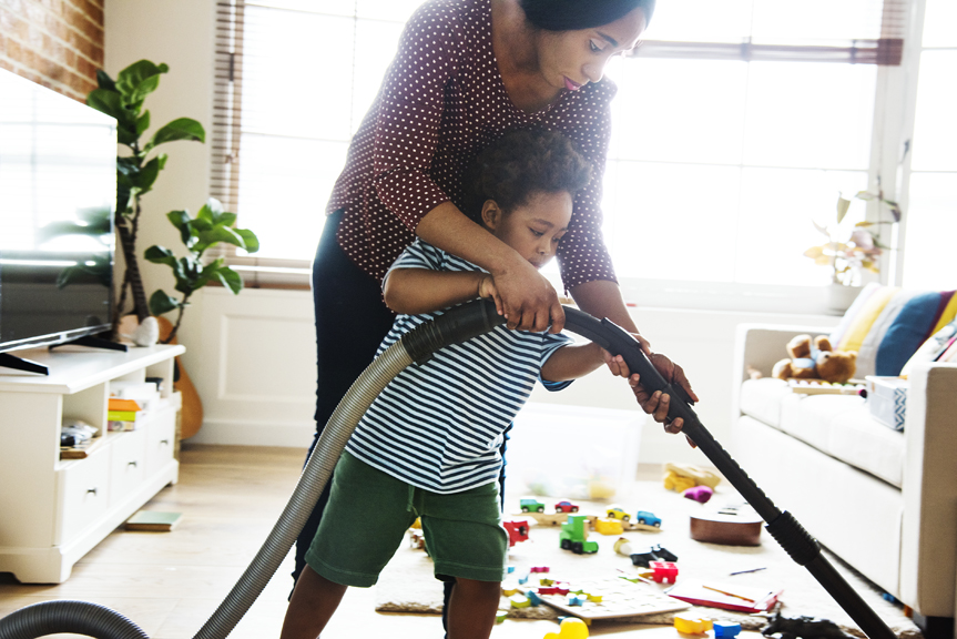 Woman and child vacuuming