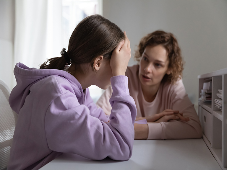 Mother talks seriously to teen girl.